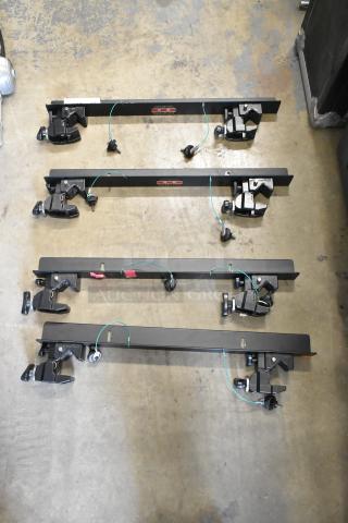 Four Matthews Studio Equipment frames, black metal, clamps attached, good condition.