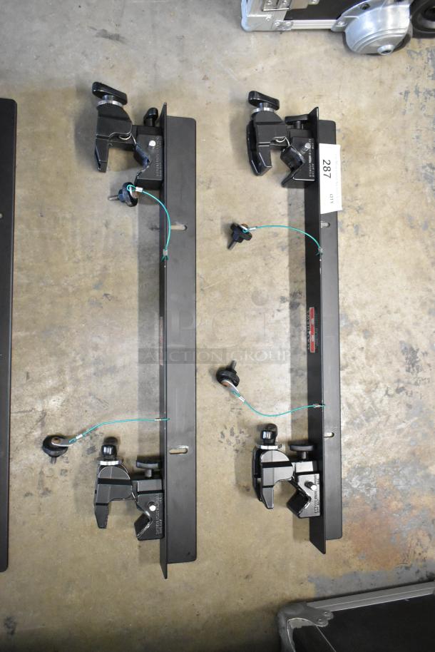 4 Matthews Studio Equipment Frames, black metal with adjustable clamps, good condition, lot label reads '287'.
