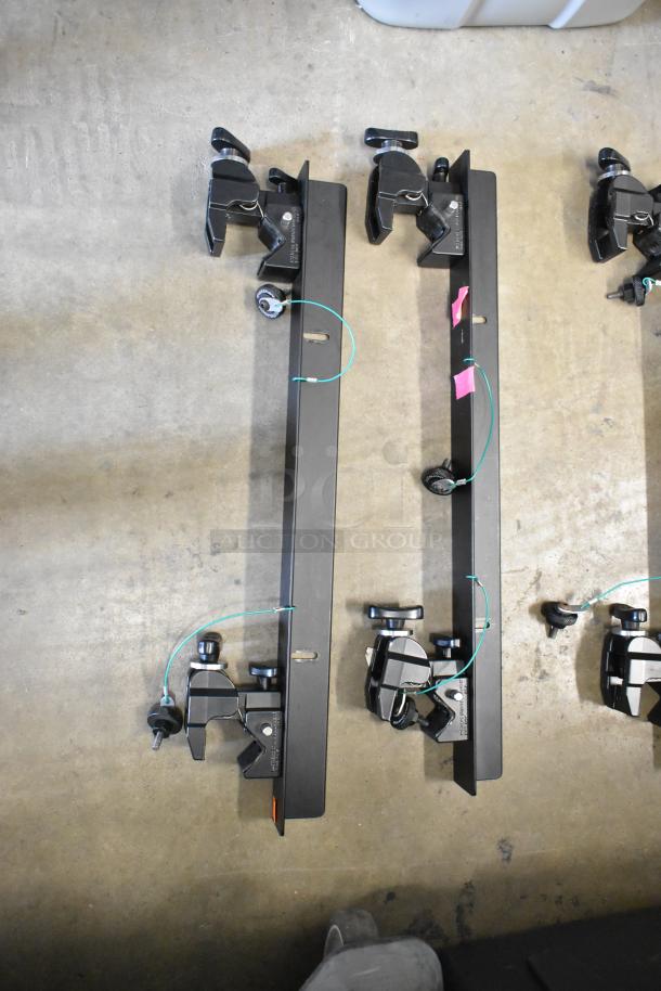Four Matthews Studio Equipment frames, black metal with clamps and tension knobs, in good condition, ideal for filmmaking setups.