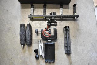 Lot of various camera equipment including Kessler handles, clamps, and brackets. Pre-owned, no visible damage.