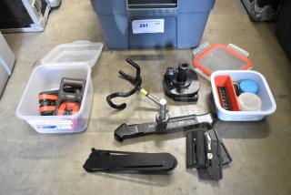 Lot of various parts and pieces in a poly bin, includes clamps, mounting brackets, and miscellaneous components. Bin labeled "291 QTY."