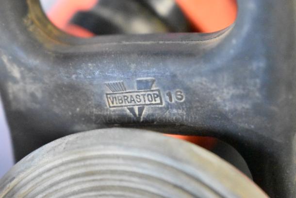 Vibrastop-marked rubber part, close-up. Part of a poly bin filled with assorted parts and pieces.