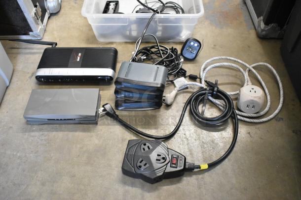 Lot of various electronics including AVS411 S-Video switch, three RadioShack RF modulators, and cables in a poly bin.