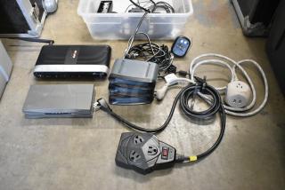 Lot of various electronics including AVS411 S-Video switch, three RadioShack RF modulators, and cables in a poly bin.