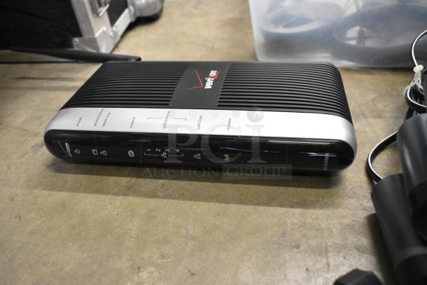 Verizon Wi-Fi router with black and silver design. Features LED indicators for power, Ethernet, and wireless connections. Model MI424WR visible.
