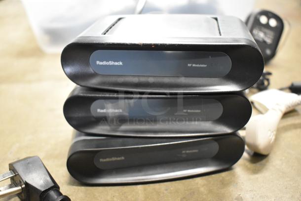 Lot of items including AVS411 infrared remote control S video switch and three RadioShack RF modulators.