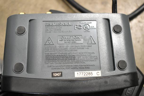 RadioShack RF Modulator back panel with caution label, model 15-2528, in used condition. Part of an AV accessory lot.