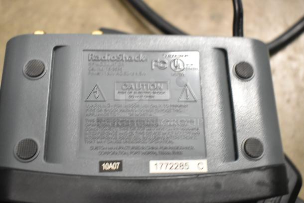 RadioShack RF Modulator in poly bin, featuring caution label with warnings and certifications. Model 15-1244.