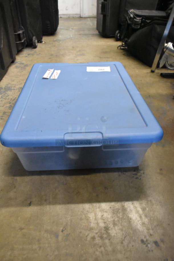 Blue poly bin containing AVS411 infrared remote control S-video switch and three RadioShack RF modulator, marked tags visible.