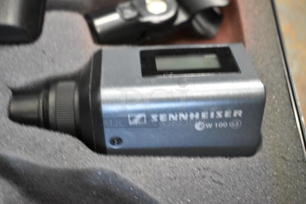 2 Sennheiser SK100 bodypack transmitters in foam case, model number visible, good condition, displays intact.