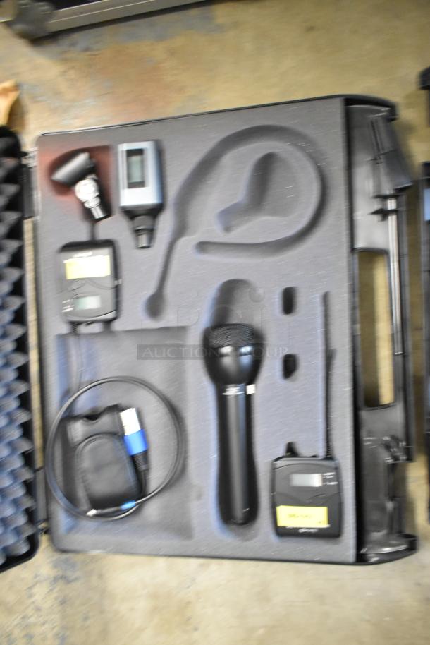 Two Sennheiser SK100 bodypack transmitters in a foam case, includes microphone and cables, good condition.