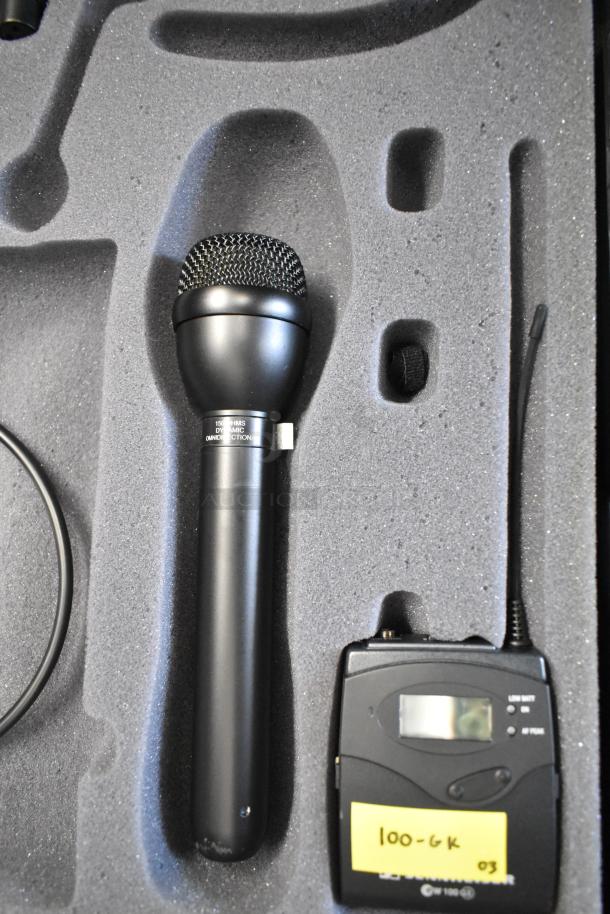 Two Sennheiser SK100 bodypack transmitters in a foam case, with mic included, labeled "100-6K 03", indicating frequency range.
