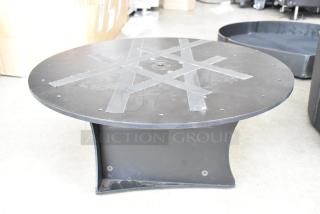 Black SKB Unit with circular top and base, in good condition. Tape markings on top surface, no visible labels or tags.