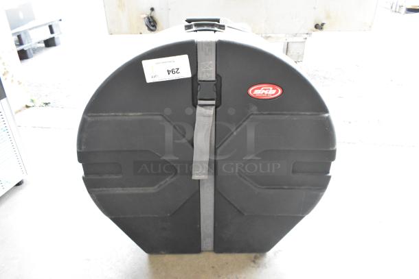 SKB Unit black hard case with strap and SKB logo, slightly worn, with label marked "294."