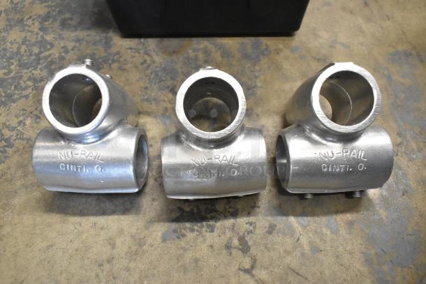 Lot of various metal fittings, featuring "NU-RAIL CINTI. O." markings, in a poly bin. High-quality industrial components.