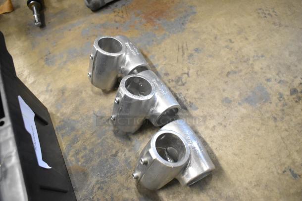 Lot of various metal fittings in poly bin, featuring three silver-tone connectors marked "Nu-Rail," in good condition.