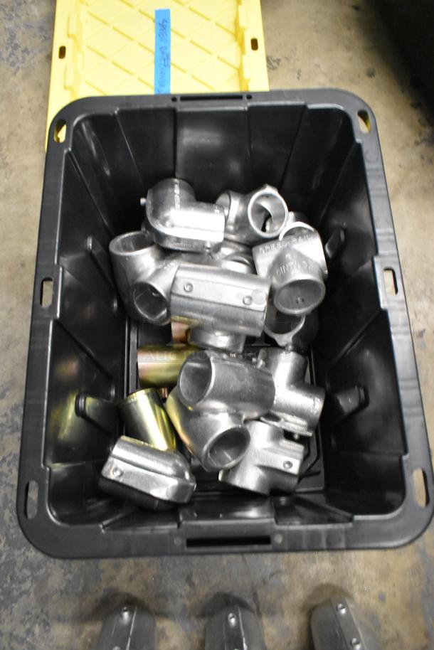 Lot of various metal fittings in poly bin, includes curved and T-shaped pieces. Bin labeled "4601 Cathy Anderson."