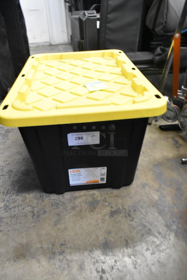 HDX Tough Tote container with yellow lid, labeled for auction lot 296. Used for storage, no visible Shane Hurlbut kit.