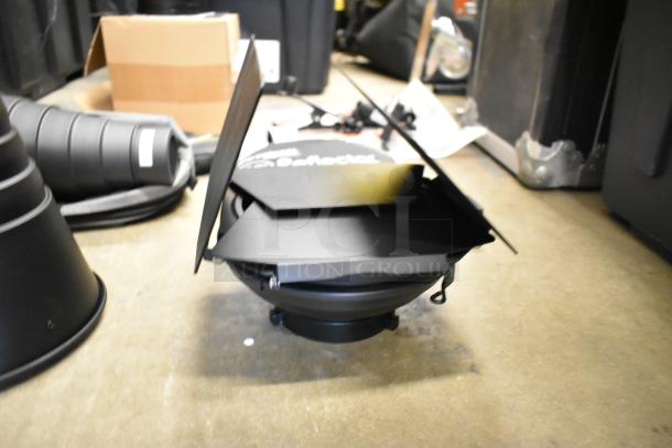Lot of photography accessories including Westcott snoot, 20" reflector, Impact ME-129 holder, umbrella reflector, and poly bin.