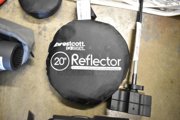 Lot includes Westcott Snoot, 20" Reflector, M-Q Mount, Impact ME-129 Reflector Holder, 55" Umbrella Reflector in poly bin.