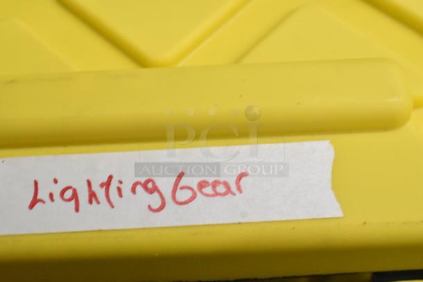 Yellow poly bin labeled "Lighting Gear," containing Westcott Snoot, Westcott 20" Reflector, M-Q Mount, Impact ME-129 Holder, 55" Umbrella Reflector.