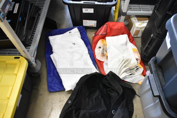 Lot of various fabric pieces in poly bin, featuring white, red, blue, and black materials. Condition appears good.