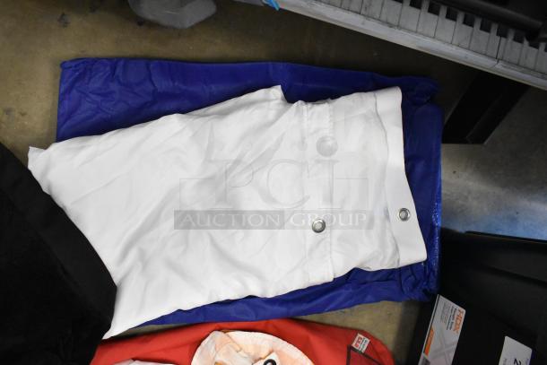 Lot of various fabric in poly bin, includes white and red textiles with metal grommets; good condition, assorted colors.