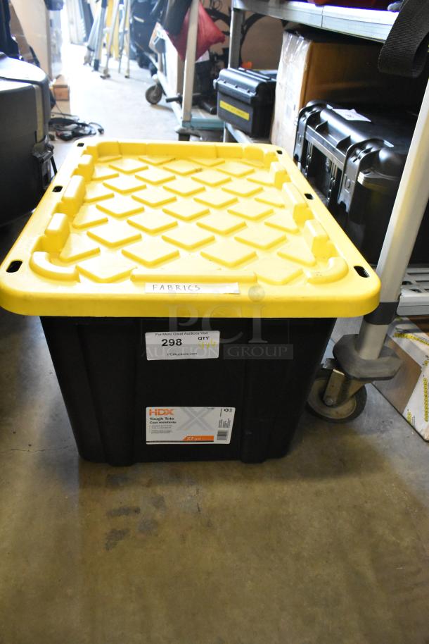 Lot of various fabric stored in a 27-gallon HDX Tough Tote poly bin with a yellow lid. Fabric label visible.