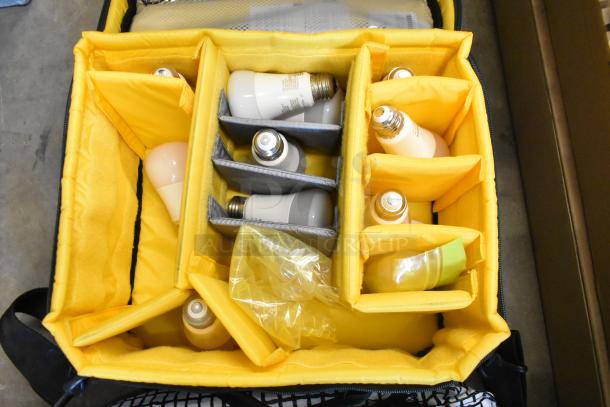 Poly bin containing assorted items, including light bulbs and fabrics, stored in a yellow organizer with compartments.