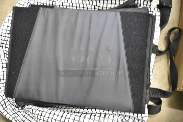 Poly bin containing an impact light stand, a lightbulb, and folded fabric with checker patterned material visible, in used condition.