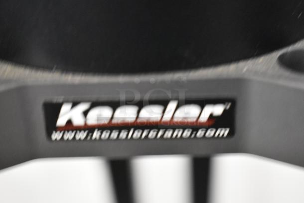 Kessler Tripod with visible logo and website on label, showcasing sturdy construction and professional-grade equipment.