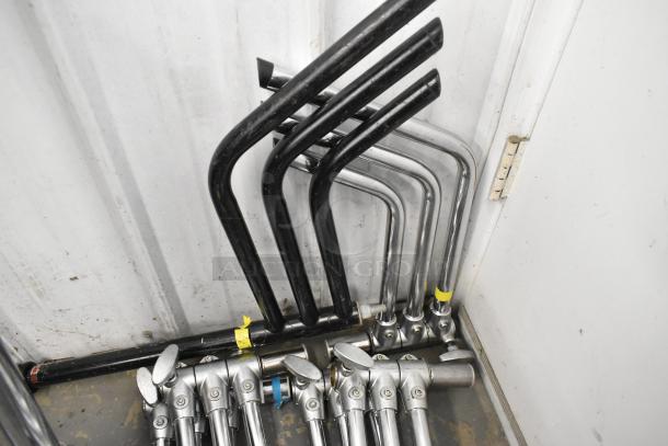 Lot of collapsible tripod pieces, includes various metal rods and connectors. Mixed condition, some with colored tags.