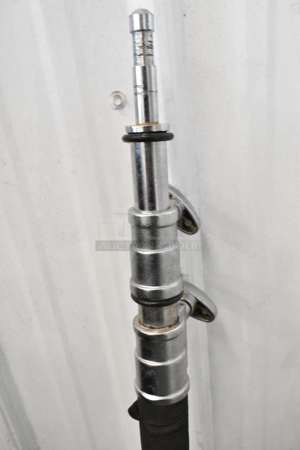 Lot of collapsible tripod pieces in silver metal, showing wear. Includes adjustment levers and rubber grips.