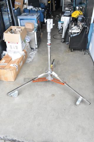 Matthews Studio Equipment tripod on casters, chrome finish, three adjustable legs, excellent condition, ideal for film production.