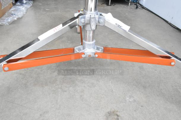 Matthews Studio Equipment tripod on casters, features sturdy metal legs and a central support, labels visible on structure.