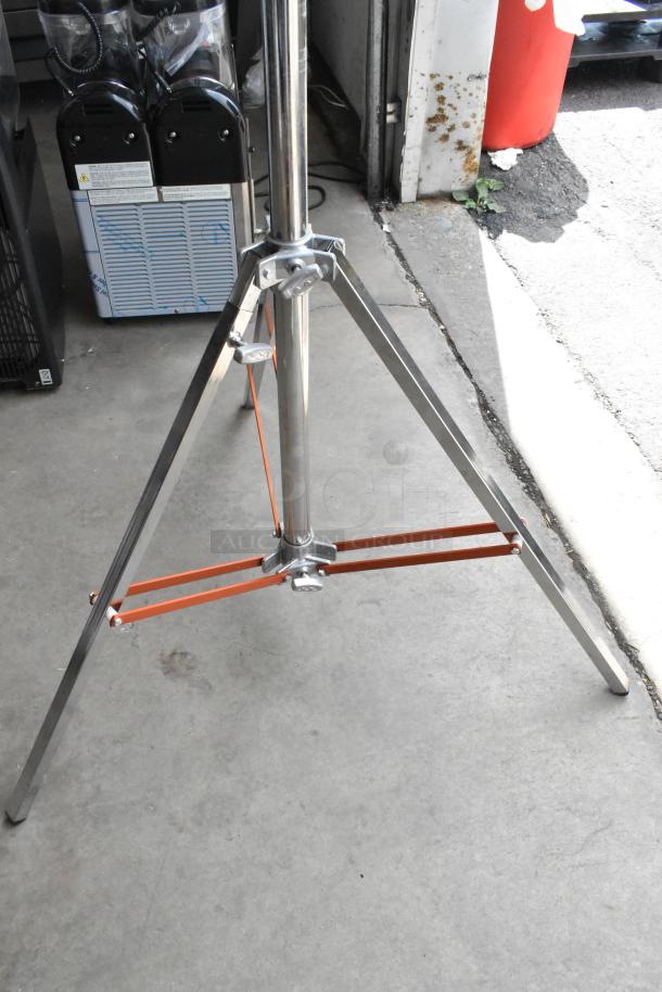 Matthews Studio Equipment tripod, steel construction, sturdy chrome finish, excellent condition, ideal for professional use.