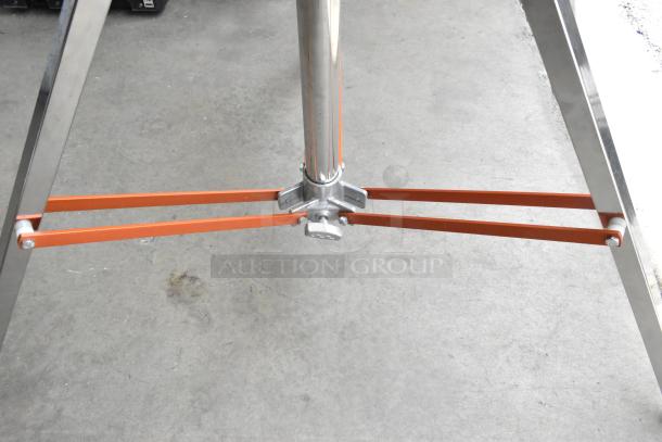 Matthews Studio Equipment Tripod in excellent condition, featuring sturdy metal legs and orange crossbars for stability.