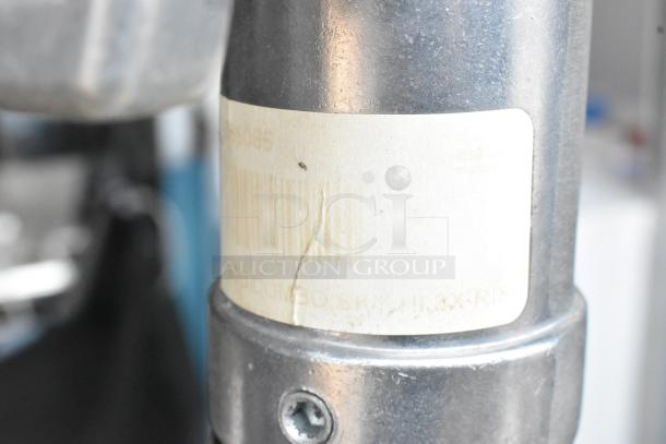Matthews Studio Equipment tripod detail with visible label, showing a metal leg and screw. Appears in good condition.