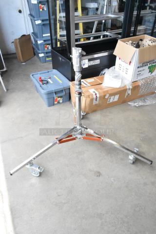 Matthews Studio Equipment tripod on casters, sturdy metal, includes soft case, excellent condition, ideal for professional use.