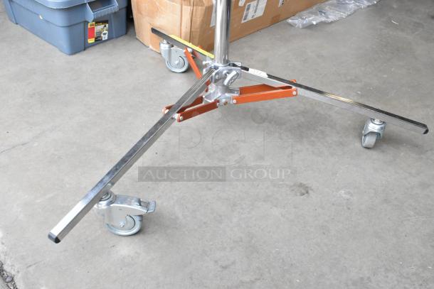 Matthews Studio Equipment tripod on casters, chrome finish, orange brackets, in soft case, excellent condition.