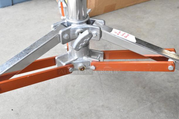 Matthews Studio Equipment tripod on casters in soft case, sturdy metal frame, includes label noting "2 Riser Combo Stand."