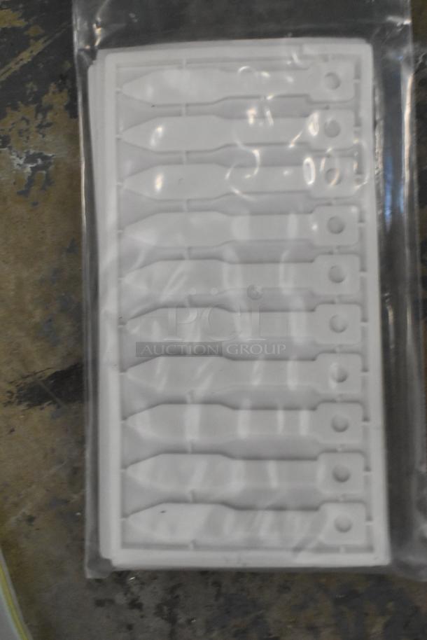 Plastic sheet with multiple detachable Kableflags in original packaging, part of a mixed auction lot.
