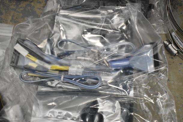 Lot of various items including Kableflags, wires, and a Vault equipment case in plastic packaging.