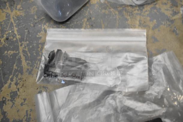 Lot of various items in a plastic bag, including Kableflags, wires, and vault equipment case. Visible "Custom SLR Strap" tag.