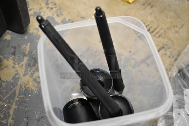 Lot including various items like Kableflags, wires, and Wacom pen components in a storage bin, indicating mixed-use condition.