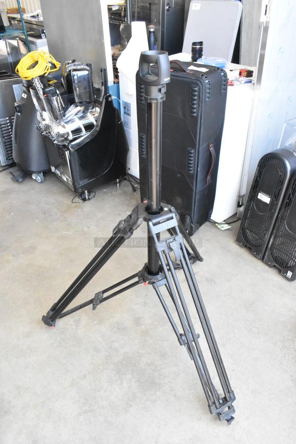 Soom tripod in soft case, good condition, sturdy aluminum legs, adjustable height, black finish, ideal for cameras.