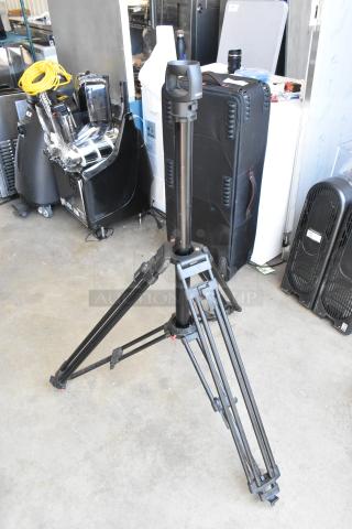 Soom tripod in soft case, good condition, sturdy aluminum legs, adjustable height, black finish, ideal for cameras.