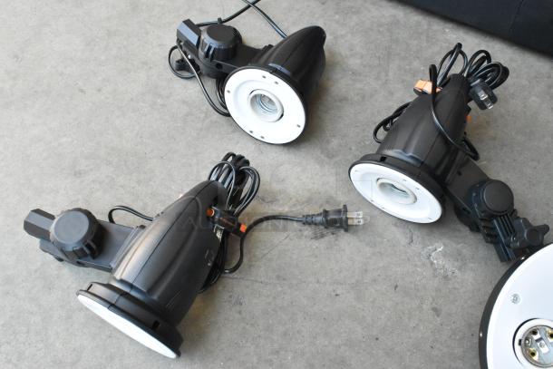 Lot of Impact FF-S1 single socket fluorescent lights, Westcott Basics D5, and wires. Includes soft case. Good condition.