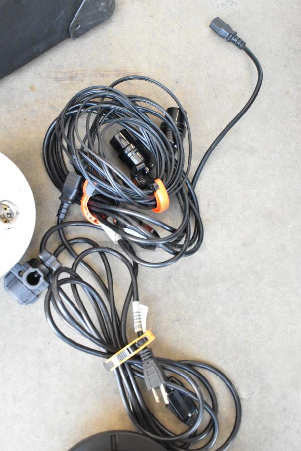 Lot of soft case with Impact FF-S1 single socket fluorescent lights, Westcott Basics D5, and bundled wires on concrete floor.
