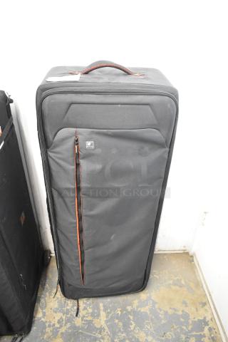 Black Kata case with durable fabric, zippered closure, and red accents. Features a top handle; in good condition. Brand logo visible.